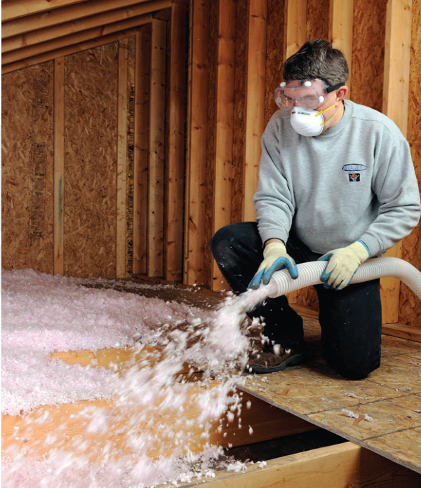 Worker handling insulation