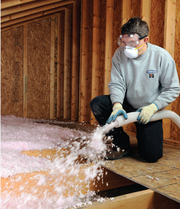 Worker handling insulation Worker handling insulation