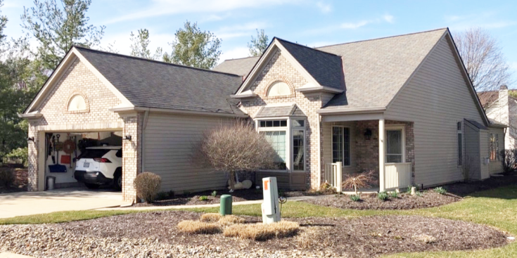 Light tan house with new roof